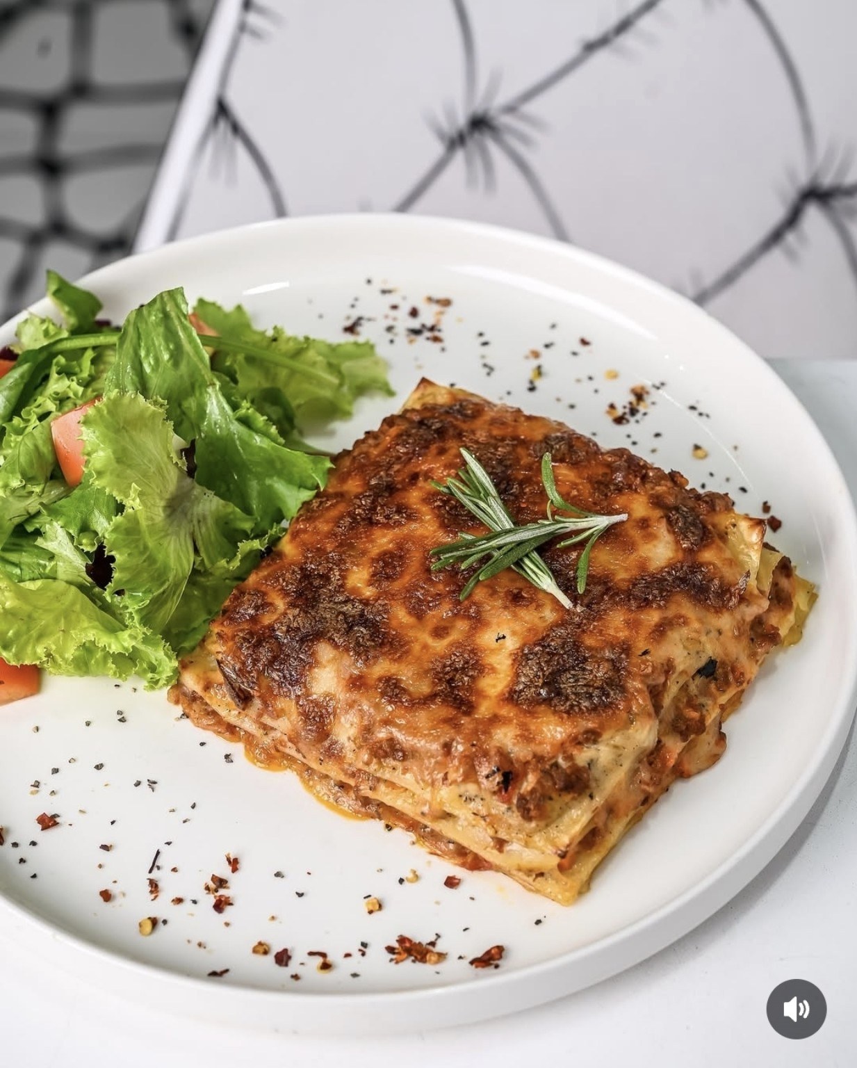 A baked dish with fresh greens at Sketch